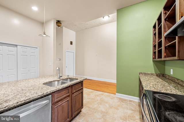 kitchen with extractor fan, decorative light fixtures, stainless steel appliances, sink, and light stone counters