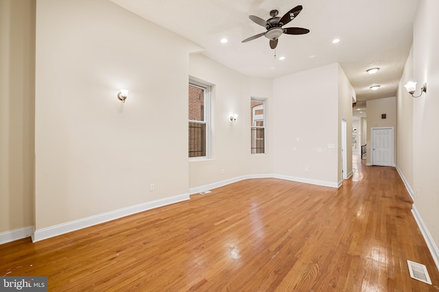 unfurnished living room featuring ceiling fan and light hardwood / wood-style flooring