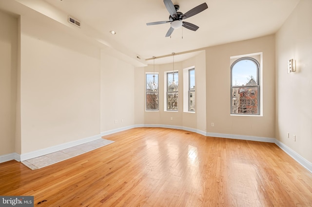 unfurnished room featuring ceiling fan and light wood-type flooring