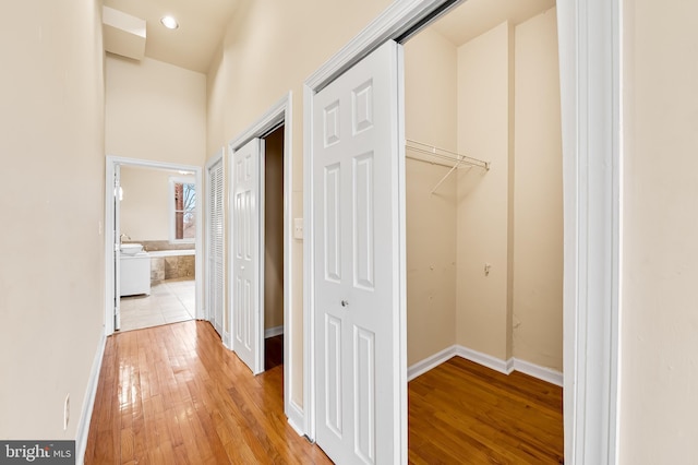 corridor with light hardwood / wood-style flooring