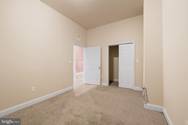 unfurnished bedroom featuring light colored carpet