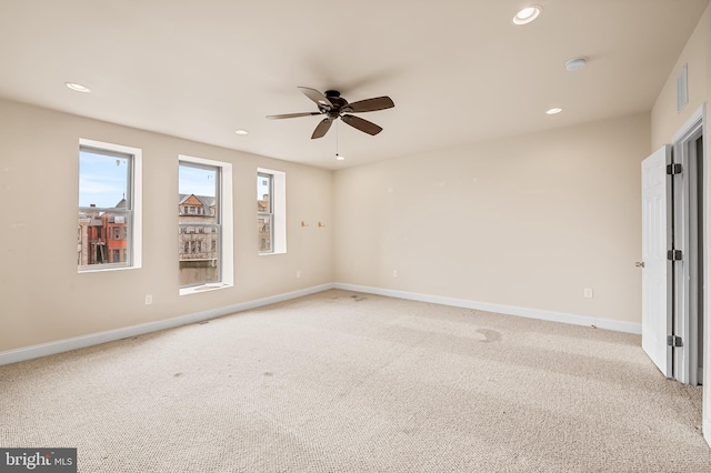 unfurnished room featuring light carpet and ceiling fan