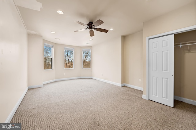 unfurnished bedroom with ceiling fan, a closet, and light colored carpet