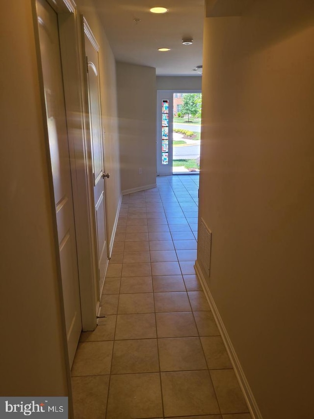 corridor with light tile patterned floors