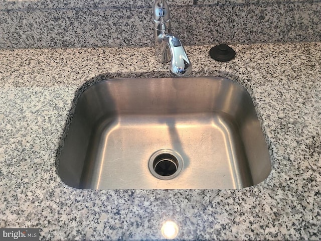 interior details with sink and stone countertops