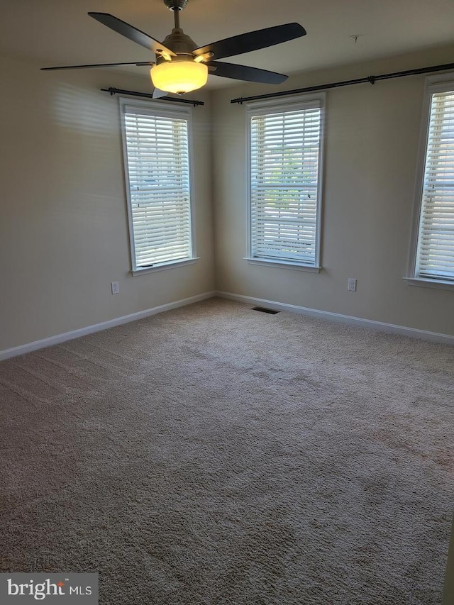 carpeted empty room with ceiling fan