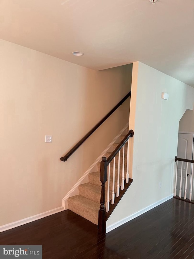 staircase featuring hardwood / wood-style flooring