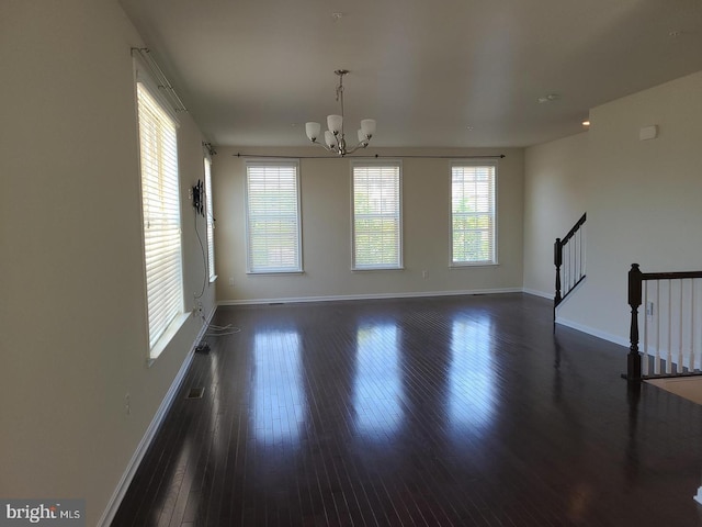 interior space featuring a chandelier and dark hardwood / wood-style floors