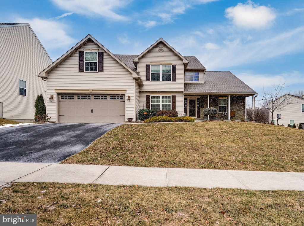 view of property featuring a front yard and a garage