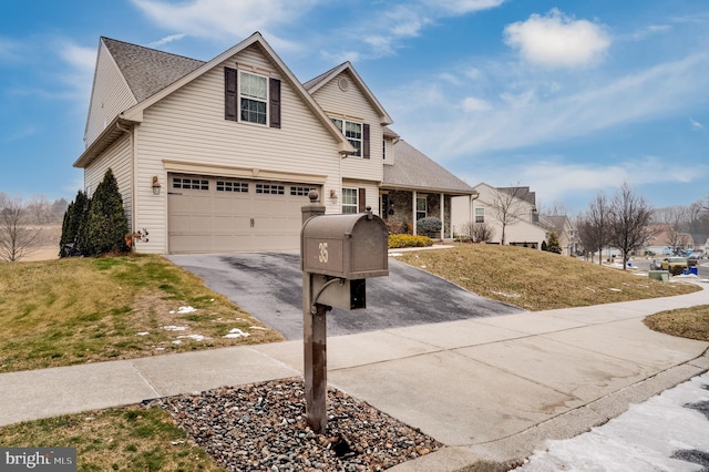 view of front property with a front lawn and a garage