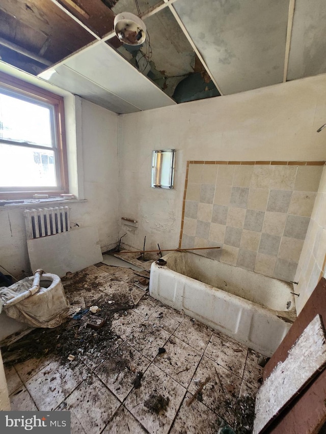 bathroom featuring a bathing tub and radiator heating unit