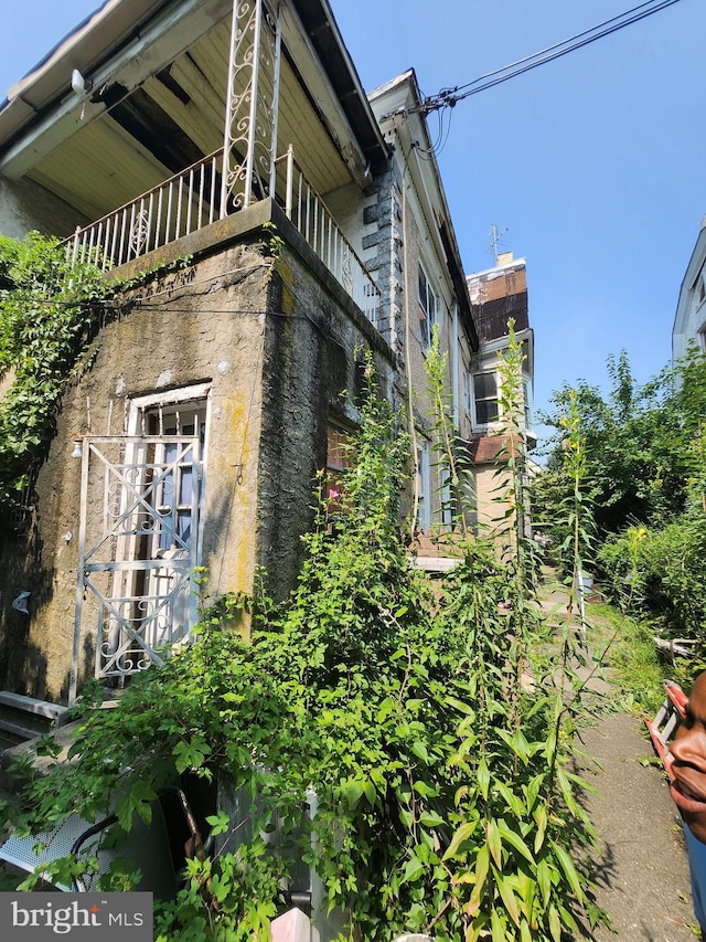 view of home's exterior with a balcony