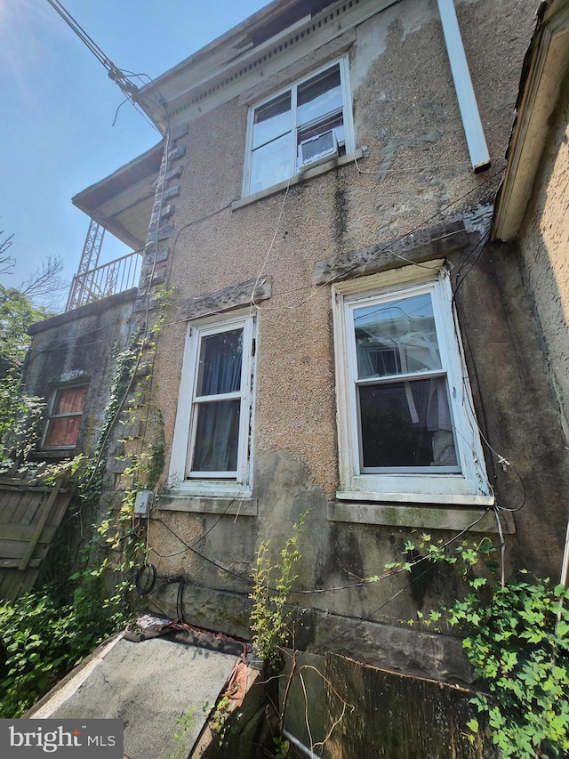 view of side of home featuring cooling unit