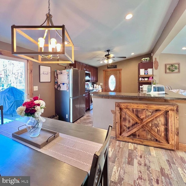 dining area with ceiling fan with notable chandelier and light wood-type flooring