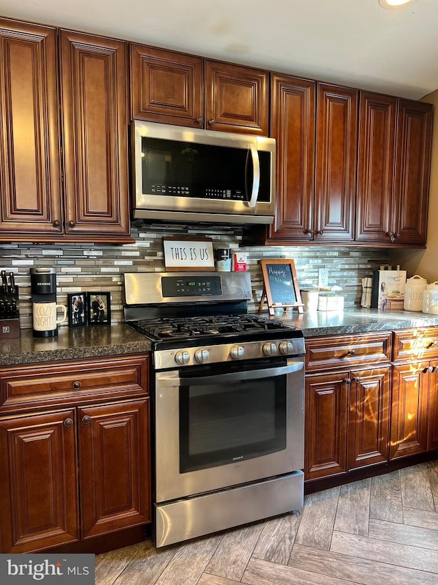 kitchen with stainless steel appliances and backsplash