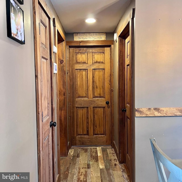 doorway with dark wood-type flooring