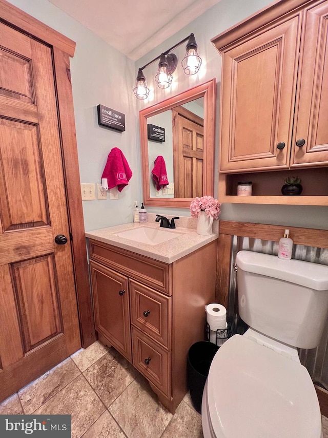 bathroom featuring toilet and vanity