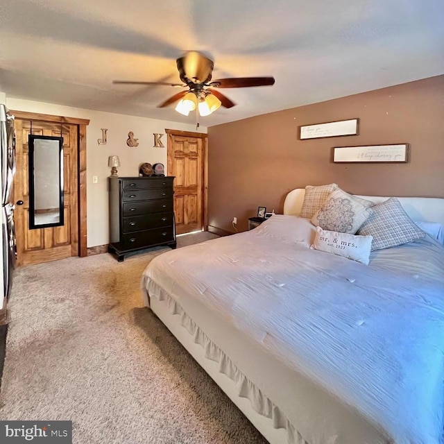 bedroom with ceiling fan and light carpet