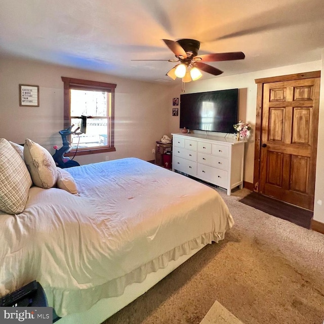 bedroom with ceiling fan and dark colored carpet