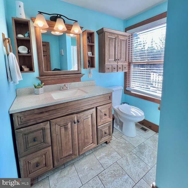 bathroom featuring toilet and vanity