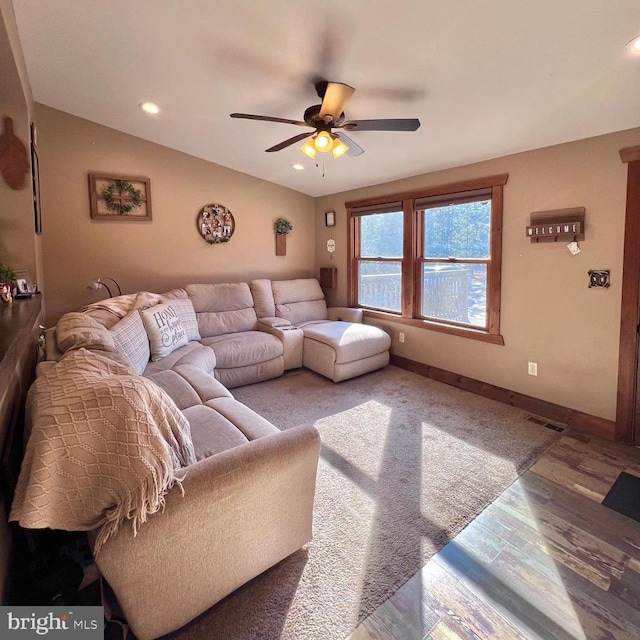 living room with lofted ceiling, hardwood / wood-style floors, and ceiling fan