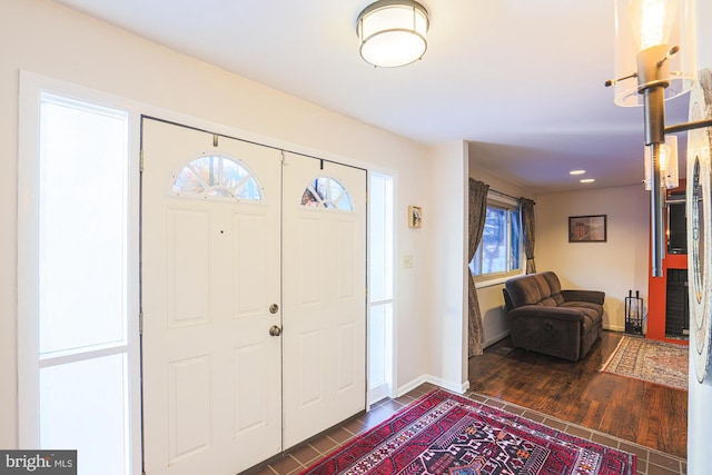 entrance foyer featuring a healthy amount of sunlight and dark hardwood / wood-style flooring