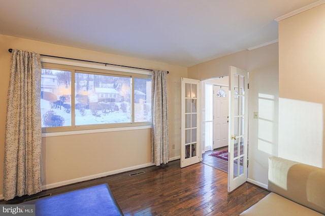 interior space with french doors, dark hardwood / wood-style flooring, and crown molding