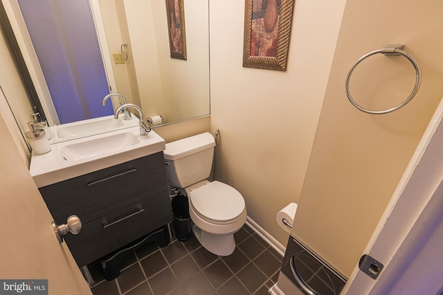 bathroom featuring toilet, tile patterned flooring, and vanity