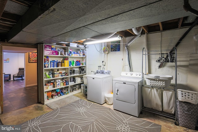 clothes washing area with separate washer and dryer