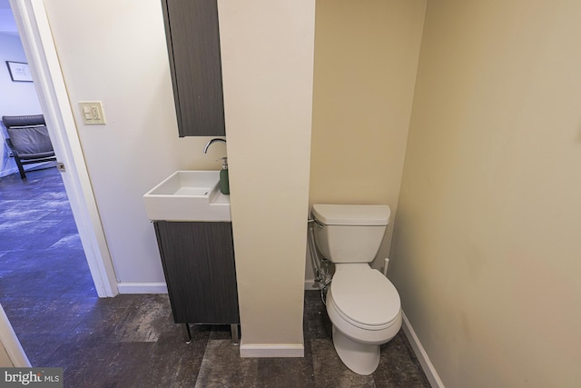 bathroom featuring toilet and vanity