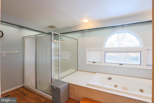 bathroom featuring hardwood / wood-style floors and separate shower and tub