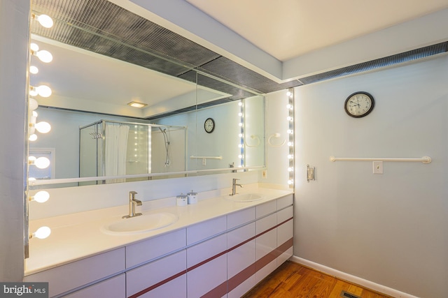 bathroom featuring vanity, hardwood / wood-style floors, and walk in shower