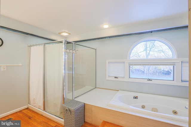 bathroom featuring hardwood / wood-style flooring and independent shower and bath