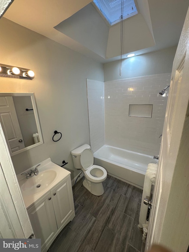 full bathroom featuring toilet, hardwood / wood-style flooring, shower / bathtub combination, and vanity