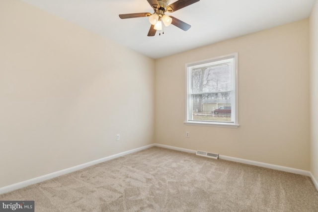 empty room with light carpet, baseboards, visible vents, and ceiling fan