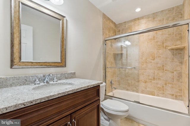 full bathroom featuring recessed lighting, combined bath / shower with glass door, vanity, and toilet