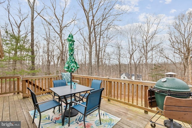 deck featuring outdoor dining area and area for grilling