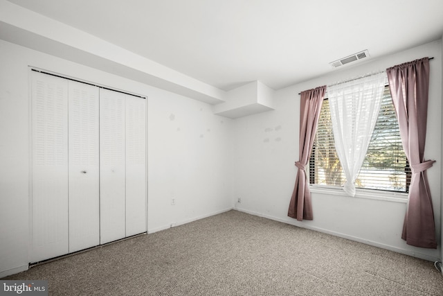 unfurnished bedroom featuring carpet floors and a closet