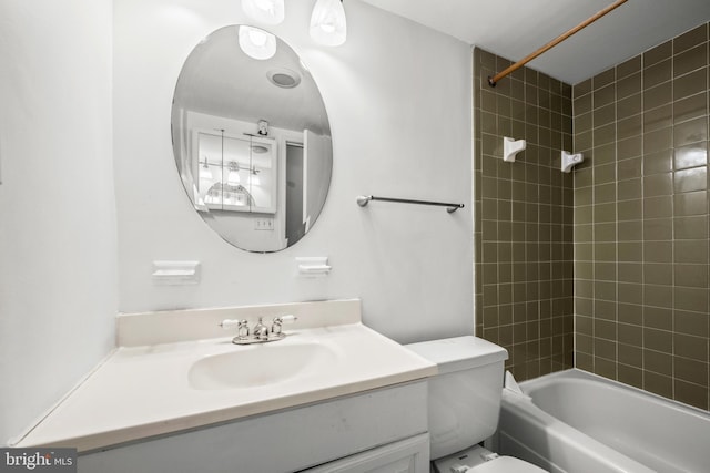 full bathroom with vanity, toilet, and tiled shower / bath combo