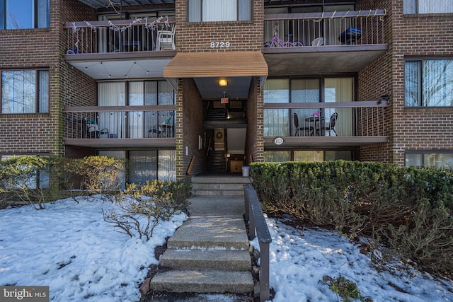 view of snow covered property entrance