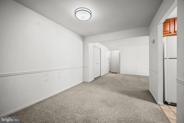 unfurnished room with light carpet