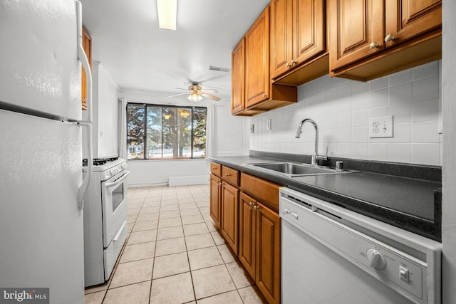 kitchen featuring white appliances, tasteful backsplash, sink, ceiling fan, and light tile patterned floors