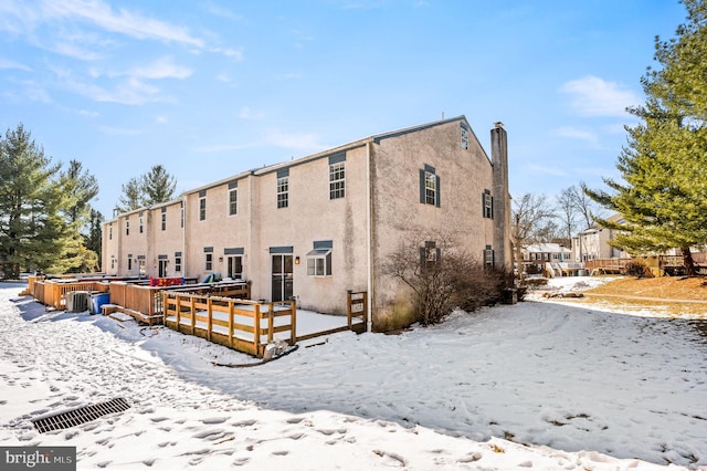 snow covered property featuring a hot tub