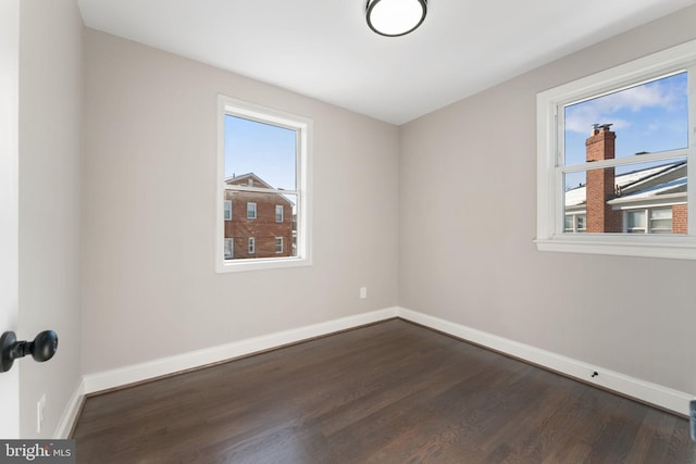 spare room with dark hardwood / wood-style floors