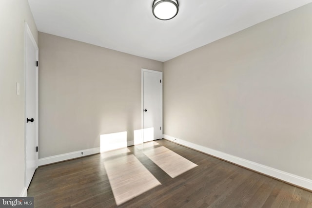 spare room with dark hardwood / wood-style floors