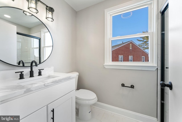 bathroom featuring toilet, walk in shower, and vanity