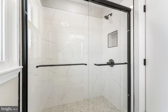 bathroom with a shower with shower door