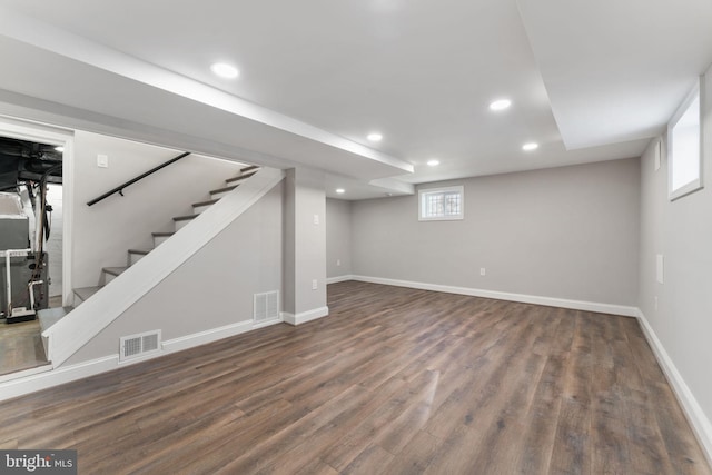 basement with dark hardwood / wood-style floors