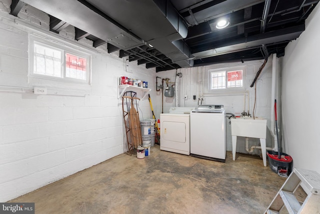 basement featuring sink and separate washer and dryer