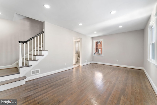 unfurnished living room featuring dark wood-type flooring